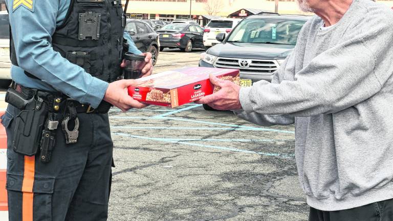 Butch Fiorentino of Byram presents a box of lasagna to Sgt. Chris Spaldo.