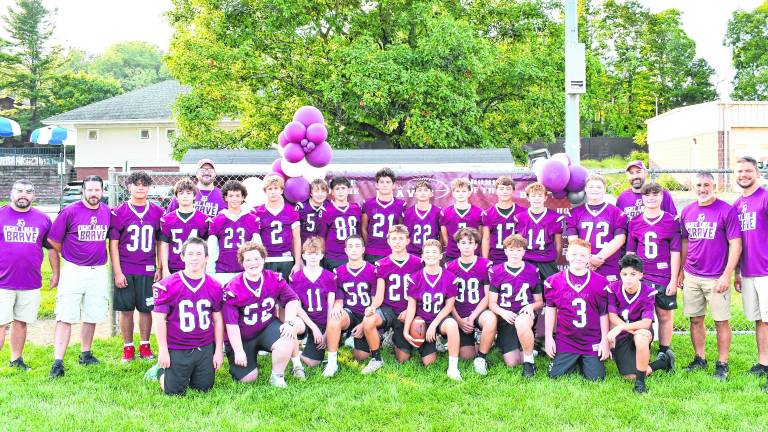 The eighth-grade football team poses for a photo.